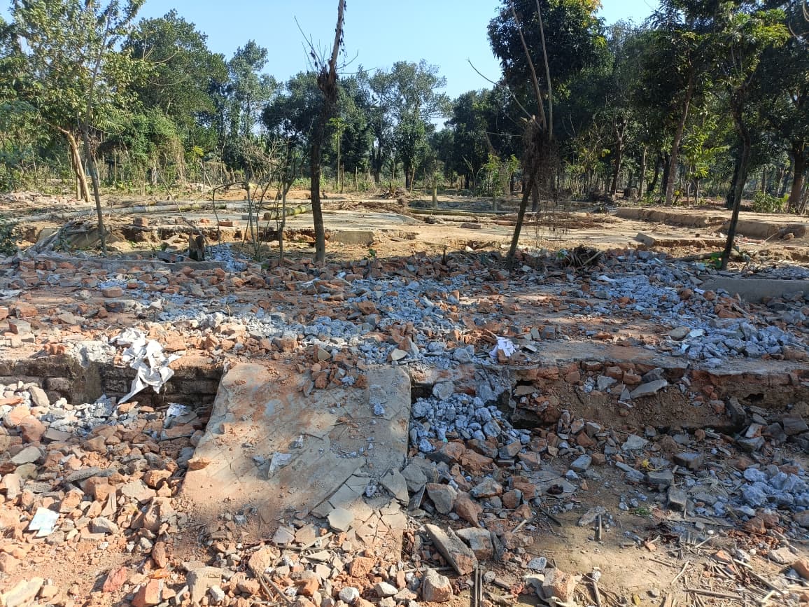 Dense concrete and brick debris covering the ground