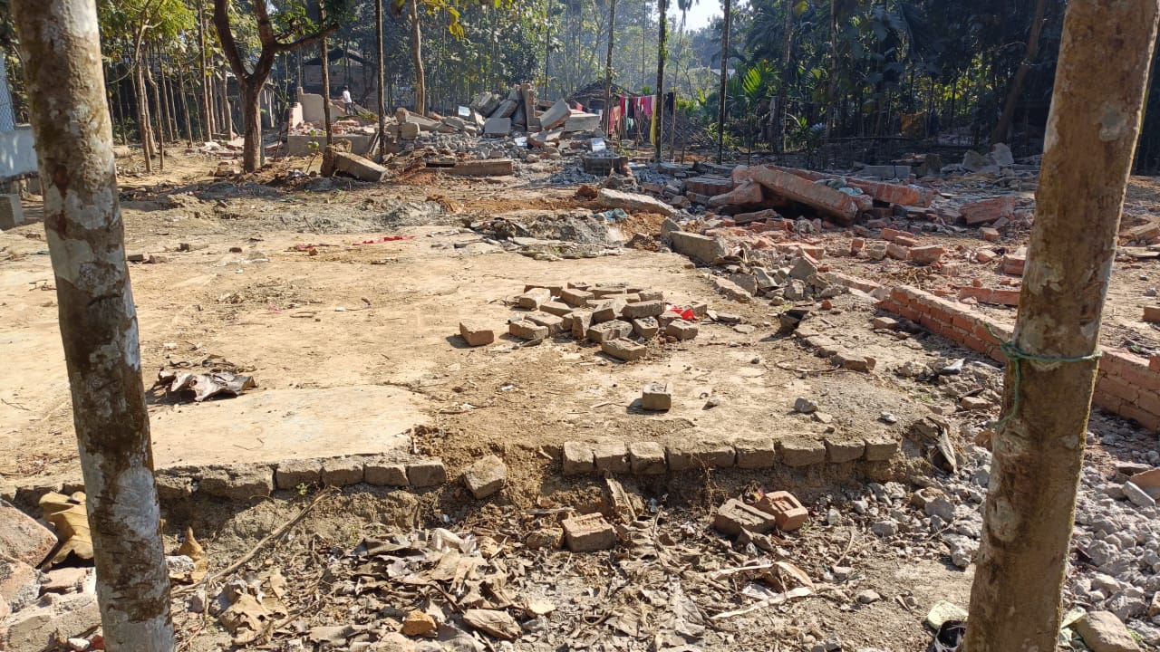 Brick rubble and cleared foundations where homes once stood